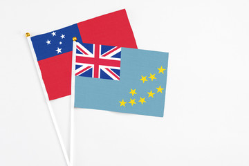 Tuvalu and Samoa stick flags on white background. High quality fabric, miniature national flag. Peaceful global concept.White floor for copy space.