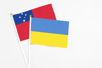 Ukraine and Samoa stick flags on white background. High quality fabric, miniature national flag. Peaceful global concept.White floor for copy space.