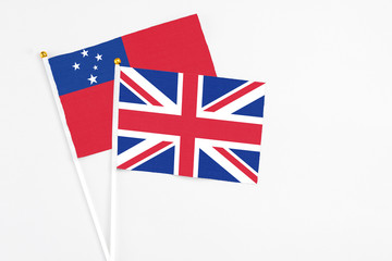 United Kingdom and Samoa stick flags on white background. High quality fabric, miniature national flag. Peaceful global concept.White floor for copy space.