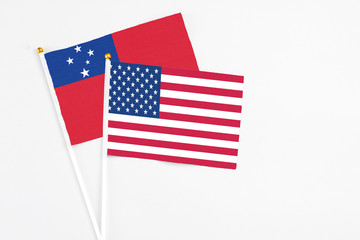 United States and Samoa stick flags on white background. High quality fabric, miniature national flag. Peaceful global concept.White floor for copy space.