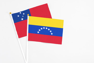 Venezuela and Samoa stick flags on white background. High quality fabric, miniature national flag. Peaceful global concept.White floor for copy space.