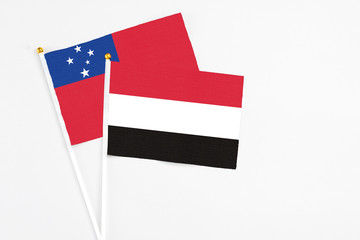 Yemen and Samoa stick flags on white background. High quality fabric, miniature national flag. Peaceful global concept.White floor for copy space.