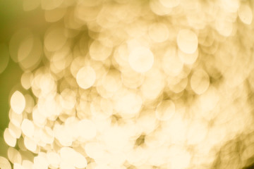 Yellow Gold Festive Christmas Beautiful abstract Background with bokeh lights. Holiday Texture with copy space. Can be used as Wallpaper, filling for a website, defocused