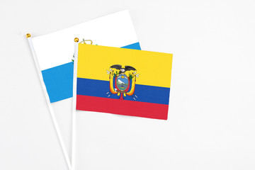 Ecuador and San Marino stick flags on white background. High quality fabric, miniature national flag. Peaceful global concept.White floor for copy space.