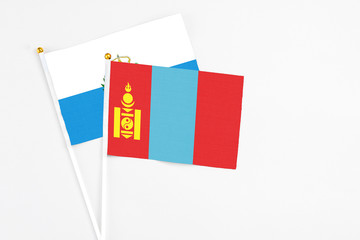 Fototapeta premium Mongolia and San Marino stick flags on white background. High quality fabric, miniature national flag. Peaceful global concept.White floor for copy space.