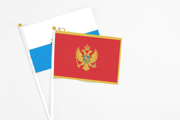 Montenegro and San Marino stick flags on white background. High quality fabric, miniature national flag. Peaceful global concept.White floor for copy space.