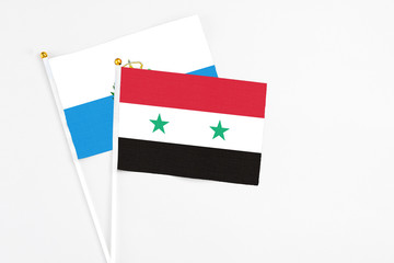 Syria and San Marino stick flags on white background. High quality fabric, miniature national flag. Peaceful global concept.White floor for copy space.