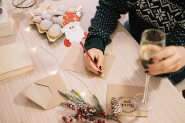 Female hand writing greeting card with red pencil