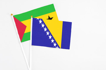 Bosnia Herzegovina and Sao Tome And Principe stick flags on white background. High quality fabric, miniature national flag. Peaceful global concept.White floor for copy space.