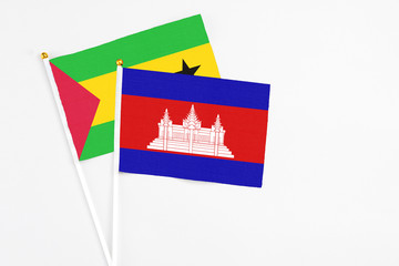Cambodia and Sao Tome And Principe stick flags on white background. High quality fabric, miniature national flag. Peaceful global concept.White floor for copy space.