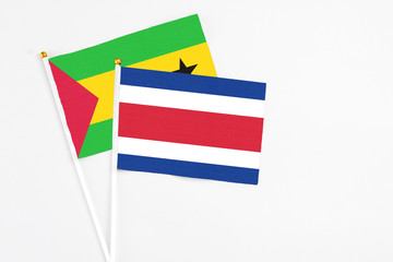 Costa Rica and Sao Tome And Principe stick flags on white background. High quality fabric, miniature national flag. Peaceful global concept.White floor for copy space.