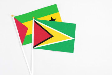 Guyana and Sao Tome And Principe stick flags on white background. High quality fabric, miniature national flag. Peaceful global concept.White floor for copy space.