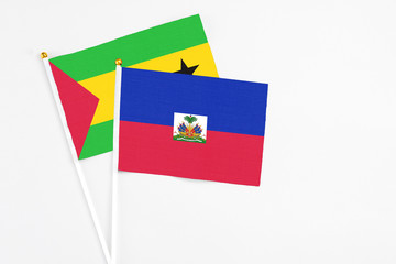 Haiti and Sao Tome And Principe stick flags on white background. High quality fabric, miniature...