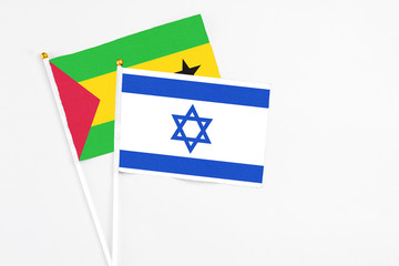 Israel and Sao Tome And Principe stick flags on white background. High quality fabric, miniature national flag. Peaceful global concept.White floor for copy space.