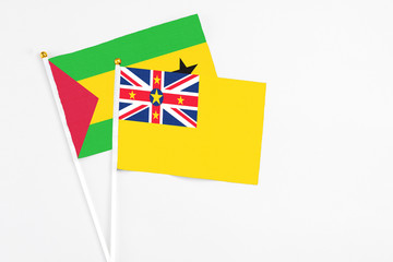 Niue and Sao Tome And Principe stick flags on white background. High quality fabric, miniature...