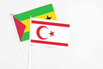 Northern Cyprus and Sao Tome And Principe stick flags on white background. High quality fabric, miniature national flag. Peaceful global concept.White floor for copy space.