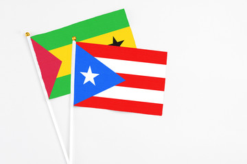 Puerto Rico and Sao Tome And Principe stick flags on white background. High quality fabric, miniature national flag. Peaceful global concept.White floor for copy space.