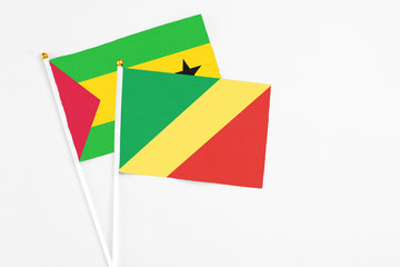 Republic Of The Congo and Sao Tome And Principe stick flags on white background. High quality fabric, miniature national flag. Peaceful global concept.White floor for copy space.