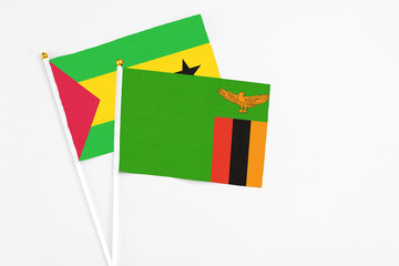 Zambia and Sao Tome And Principe stick flags on white background. High quality fabric, miniature national flag. Peaceful global concept.White floor for copy space.