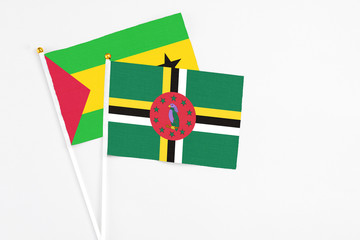 Dominica and Saudi Arabia stick flags on white background. High quality fabric, miniature national...