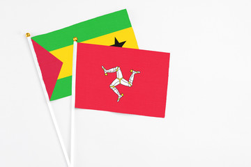 Isle Of Man and Saudi Arabia stick flags on white background. High quality fabric, miniature national flag. Peaceful global concept.White floor for copy space.