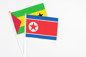 North Korea and Saudi Arabia stick flags on white background. High quality fabric, miniature national flag. Peaceful global concept.White floor for copy space.