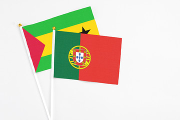 Portugal and Saudi Arabia stick flags on white background. High quality fabric, miniature national flag. Peaceful global concept.White floor for copy space.