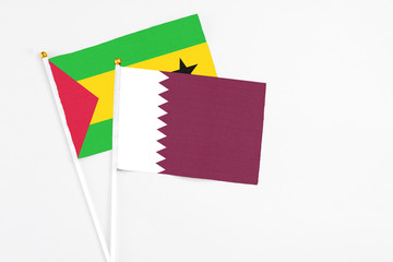 Qatar and Saudi Arabia stick flags on white background. High quality fabric, miniature national flag. Peaceful global concept.White floor for copy space.