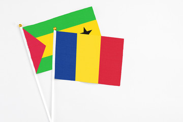 Romania and Saudi Arabia stick flags on white background. High quality fabric, miniature national flag. Peaceful global concept.White floor for copy space.