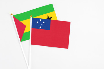 Samoa and Saudi Arabia stick flags on white background. High quality fabric, miniature national flag. Peaceful global concept.White floor for copy space.