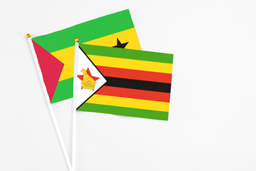 Zimbabwe and Saudi Arabia stick flags on white background. High quality fabric, miniature national flag. Peaceful global concept.White floor for copy space.