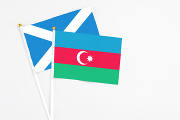 Azerbaijan and Scotland stick flags on white background. High quality fabric, miniature national flag. Peaceful global concept.White floor for copy space.