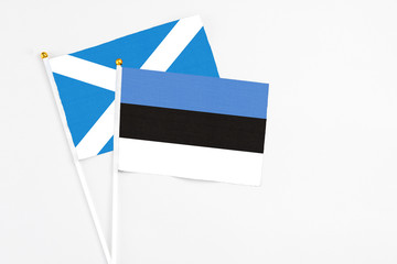 Estonia and Scotland stick flags on white background. High quality fabric, miniature national flag. Peaceful global concept.White floor for copy space.