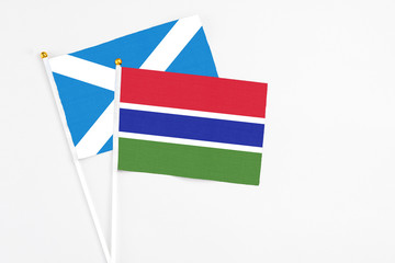 Gambia and Scotland stick flags on white background. High quality fabric, miniature national flag. Peaceful global concept.White floor for copy space.