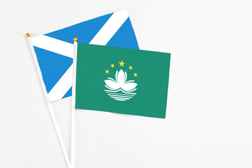 Macao and Scotland stick flags on white background. High quality fabric, miniature national flag. Peaceful global concept.White floor for copy space.