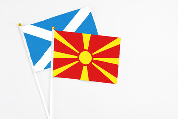 Macedonia and Scotland stick flags on white background. High quality fabric, miniature national flag. Peaceful global concept.White floor for copy space.