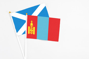 Mongolia and Scotland stick flags on white background. High quality fabric, miniature national flag. Peaceful global concept.White floor for copy space.