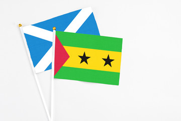 Sao Tome And Principe and Scotland stick flags on white background. High quality fabric, miniature national flag. Peaceful global concept.White floor for copy space.