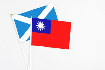 Taiwan and Scotland stick flags on white background. High quality fabric, miniature national flag. Peaceful global concept.White floor for copy space.