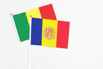 Andorra and Senegal stick flags on white background. High quality fabric, miniature national flag. Peaceful global concept.White floor for copy space.