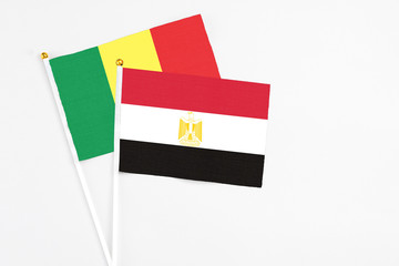 Egypt and Senegal stick flags on white background. High quality fabric, miniature national flag. Peaceful global concept.White floor for copy space.