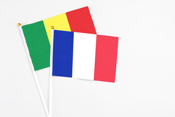 France and Senegal stick flags on white background. High quality fabric, miniature national flag. Peaceful global concept.White floor for copy space.