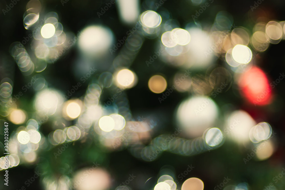 Aufkleber Abstract color blur decoration ball and light string on christmas tree with bokeh light background.winter holiday seasonal