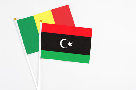 Libya and Senegal stick flags on white background. High quality fabric, miniature national flag. Peaceful global concept.White floor for copy space.