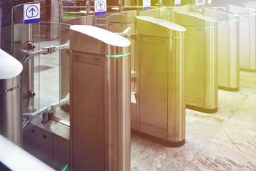 Turnstiles in the subway. Access system of public transport in the city. Urban image.