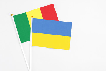 Ukraine and Senegal stick flags on white background. High quality fabric, miniature national flag. Peaceful global concept.White floor for copy space.