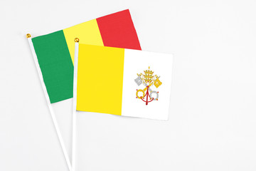 Vatican City and Senegal stick flags on white background. High quality fabric, miniature national flag. Peaceful global concept.White floor for copy space.