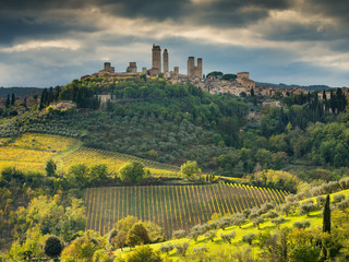 san rays on the hill and view to San Gimignano in Tuscany in Italy