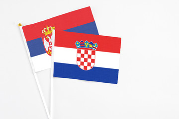 Croatia and Serbia stick flags on white background. High quality fabric, miniature national flag....