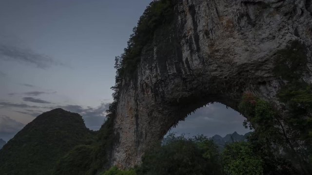 Sunset and cloudscape over Moon Hill arch karst mountain, time lapse